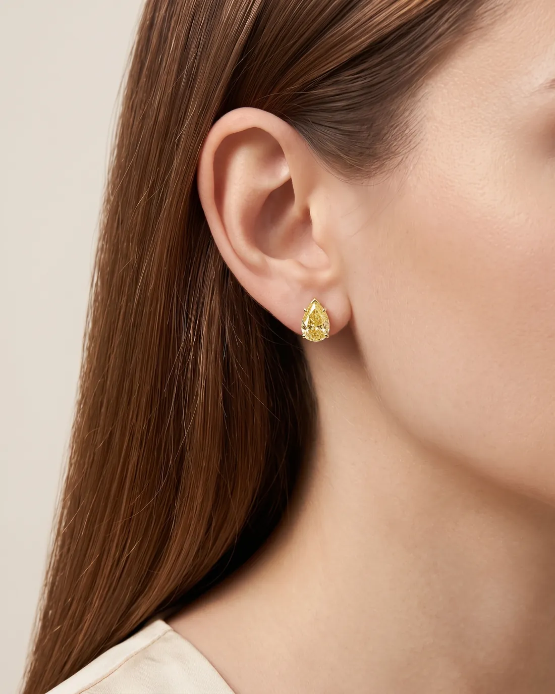 ORTIGAS Yellow Pear Studs earrings, worn on the ear