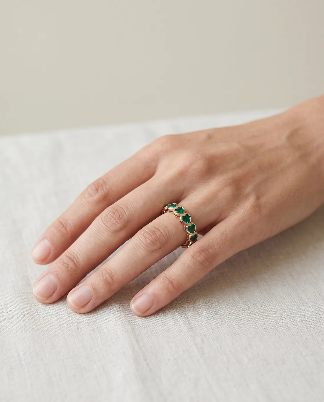 ORTIGAS Rose Emerald Band ring, worn on the hand